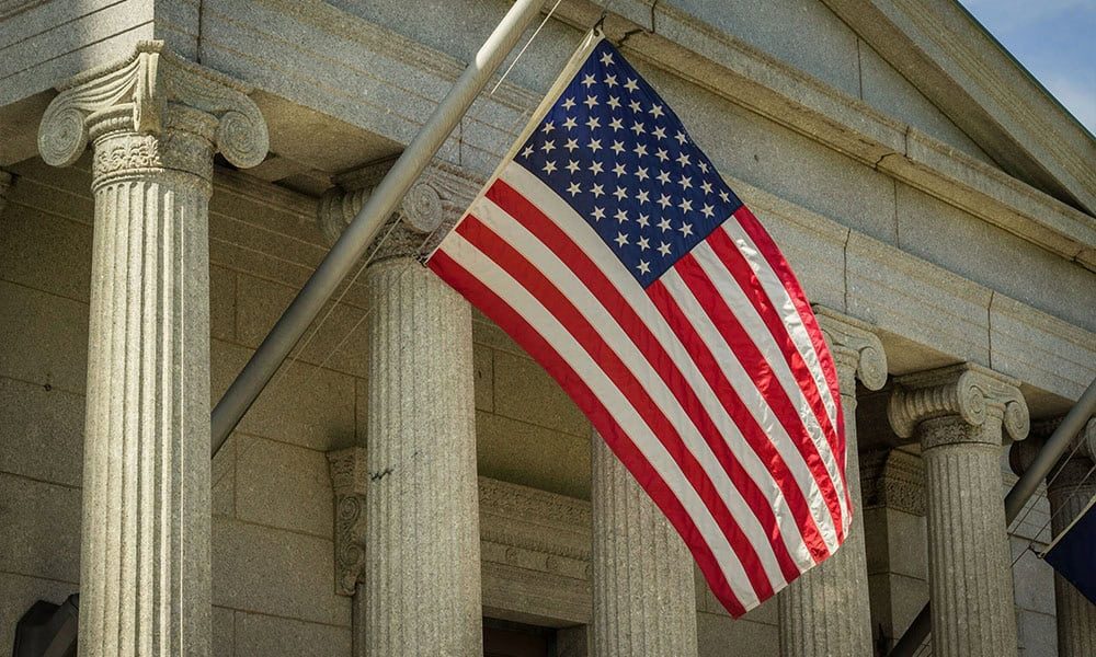 American flag outside a courthouse representing court filing services in Huntsville, Alabama